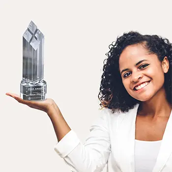 A photo of a woman holding a crystal award.